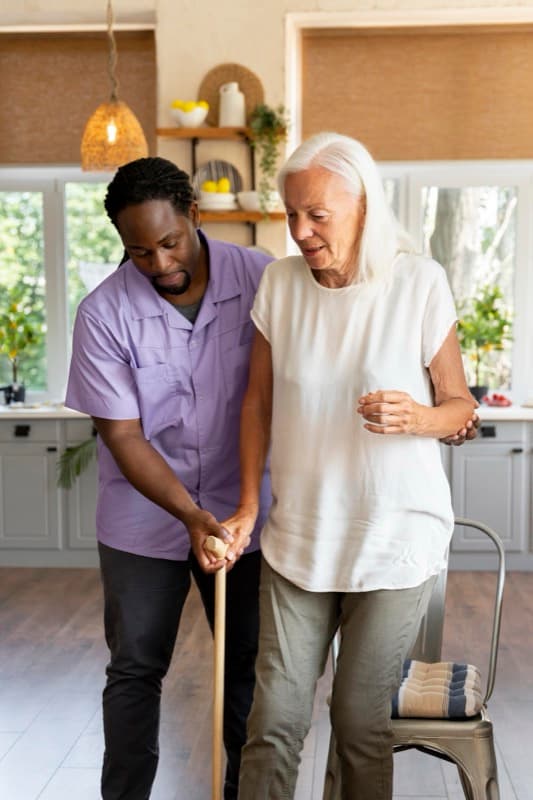 Experienced caregiver assisting elderly client